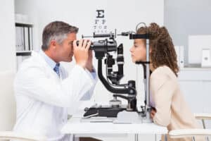 Woman doing eye test with optometrist in medical office